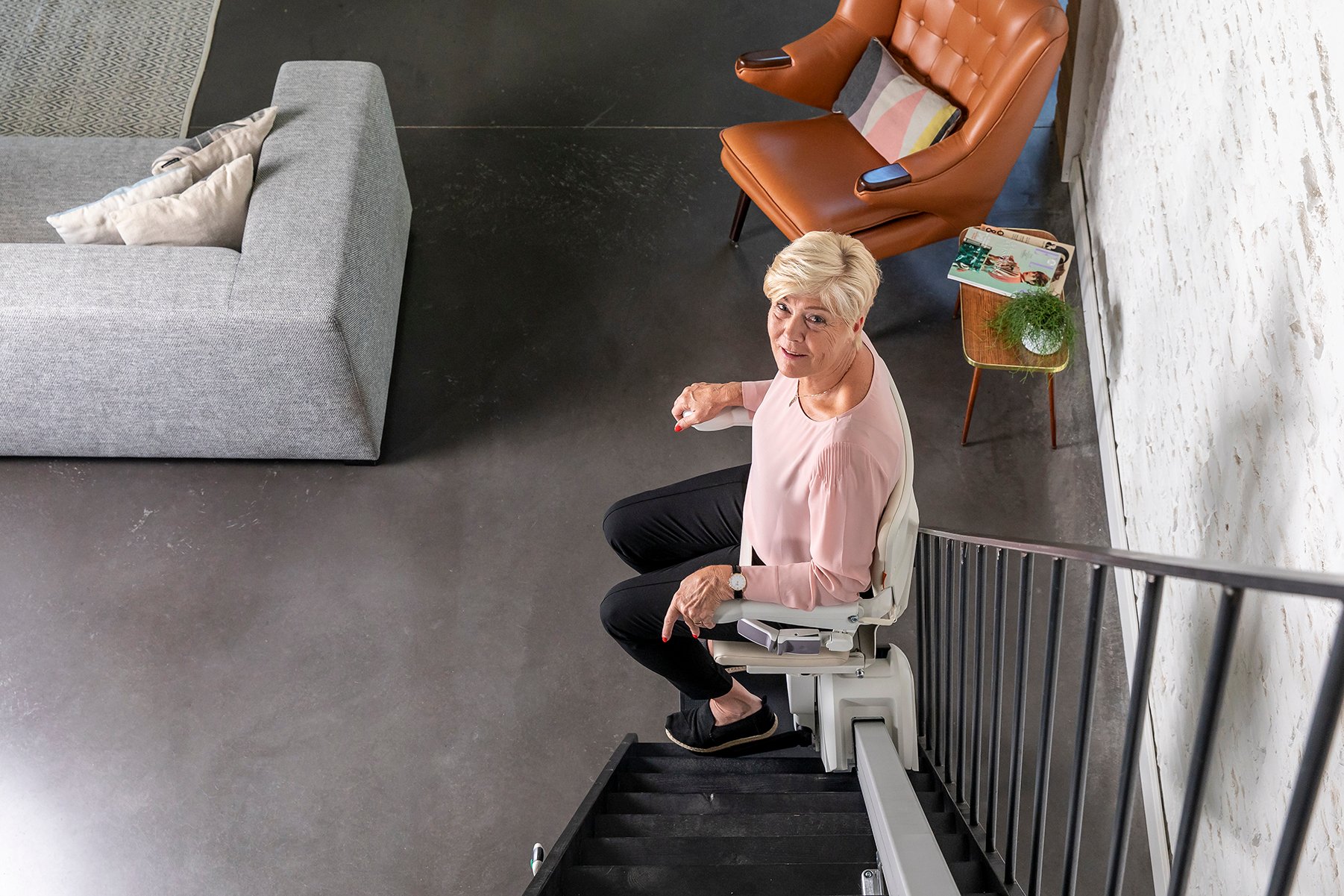 1100-woman-sitting-stairlift-downstairs